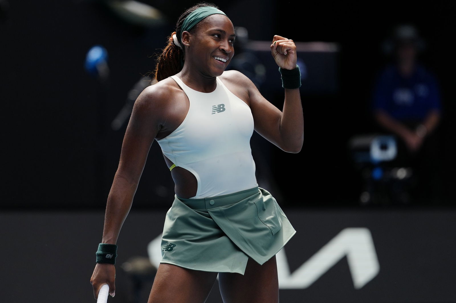 Gauff smiles and hold up a fist. 