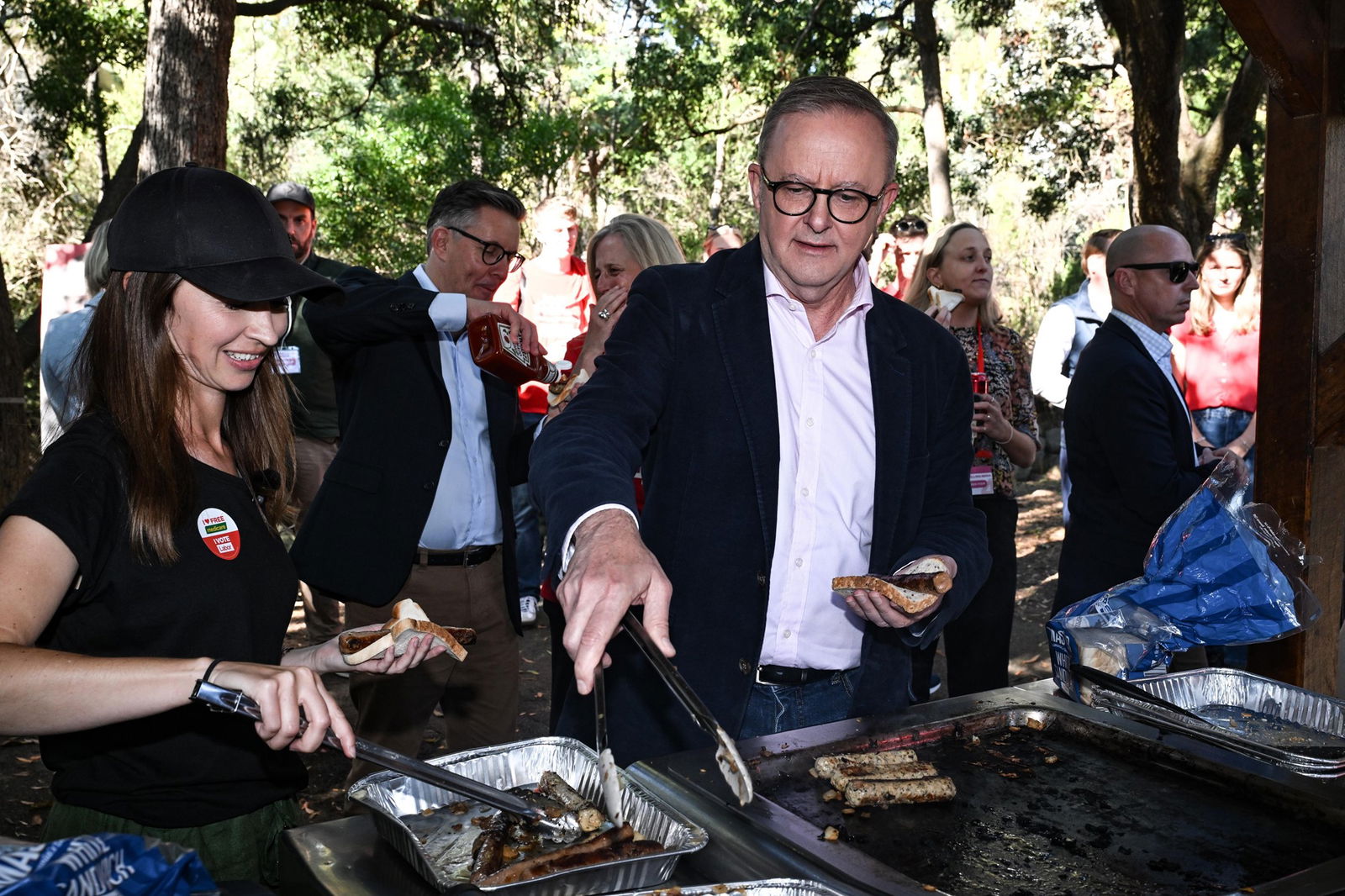 Jess Teesdale and Anthony Albanese man the barbecue.
