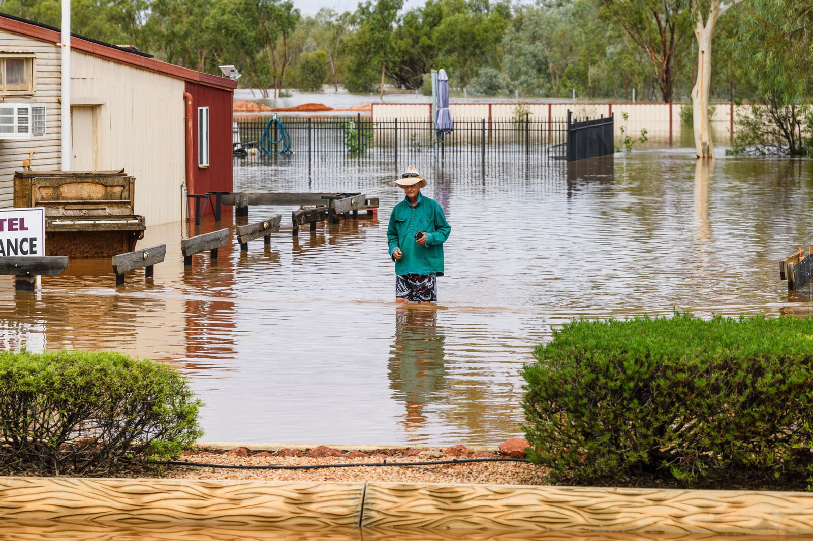 A person stand in floodwaters.