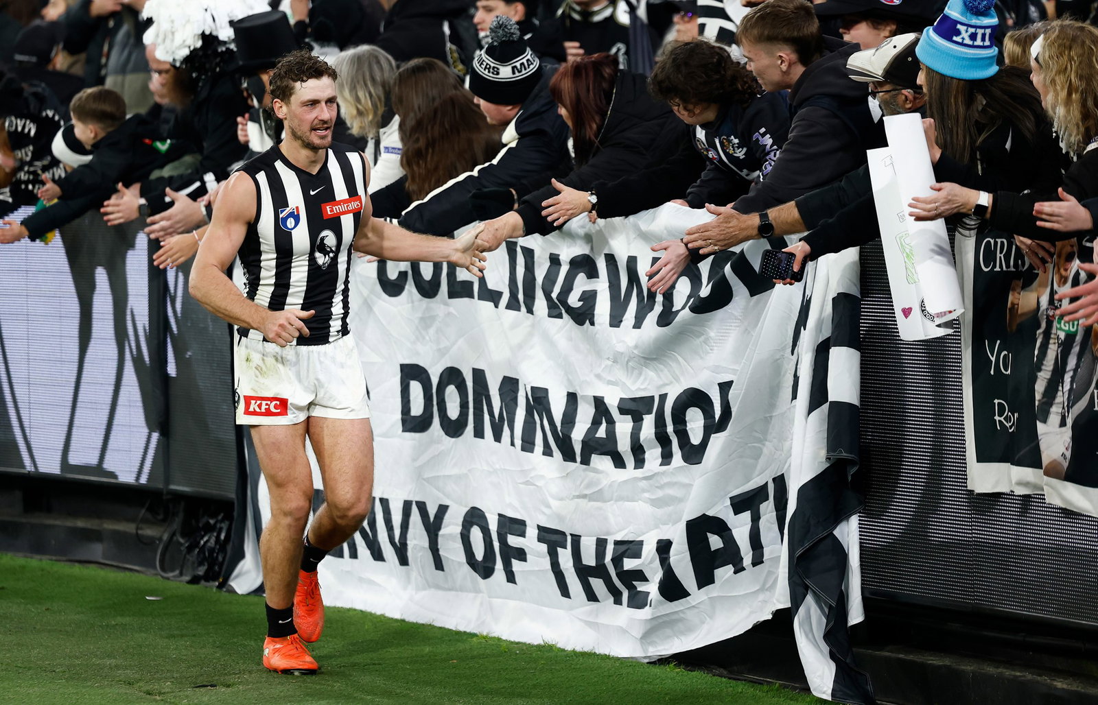 Harry Perryman of the Magpies celebrates with fans during the 2026 AFL Round 19 match between the Collingwood Magpies and the Carlton Blues at the Melbourne Cricket Ground on July 18, 2026 in Melbourne, Australia.