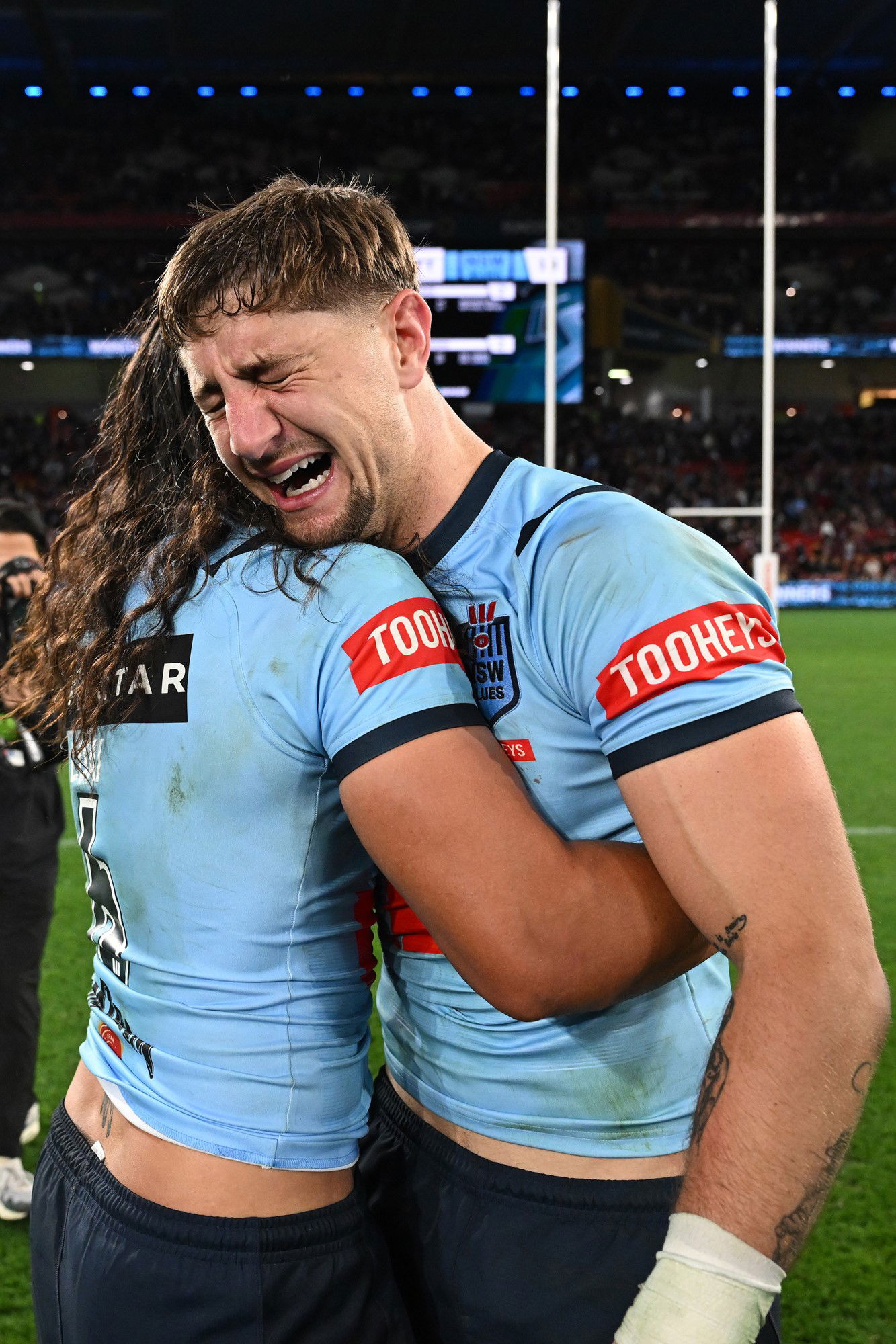 NSW Blues players Jarome Luai and Zac Lomax hug each other after the State of Origin decider.