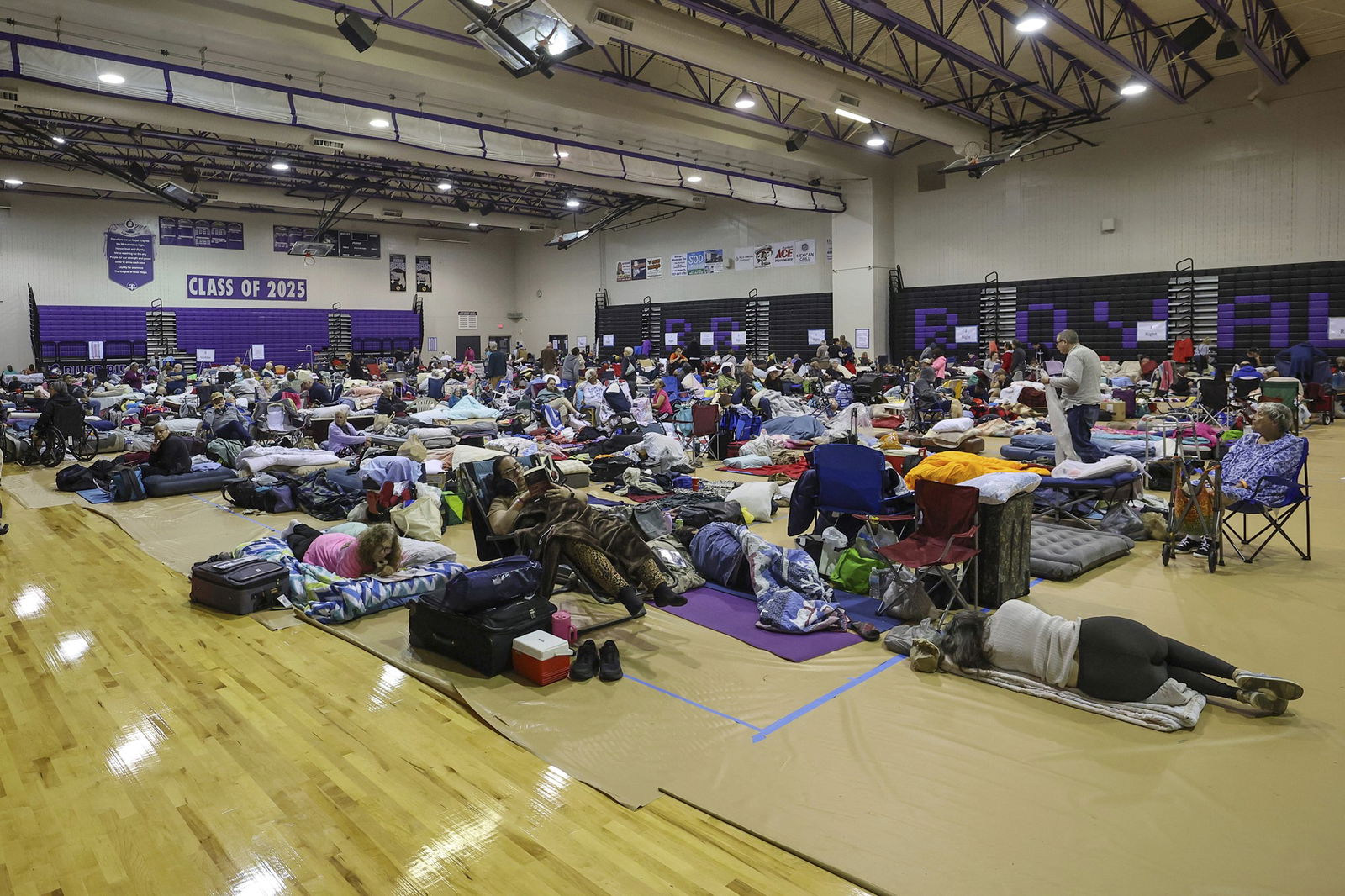 A large group of people in an evacuation centre. 