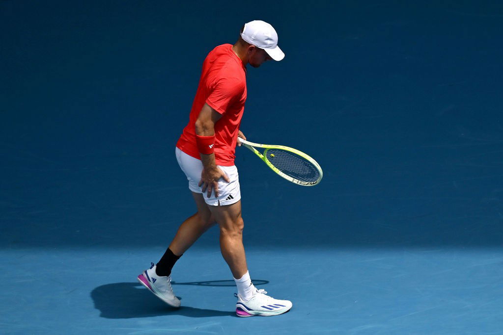 Alejandro Davidovich Fokina holds his leg at the Australian Open.