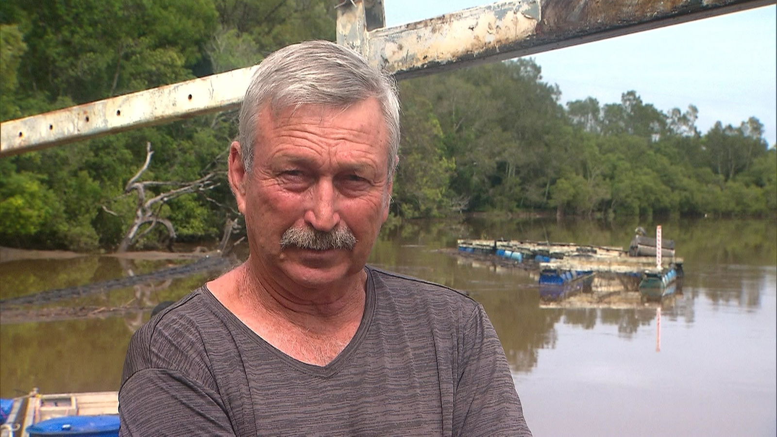 John Lindsay standing in front of floodwaters