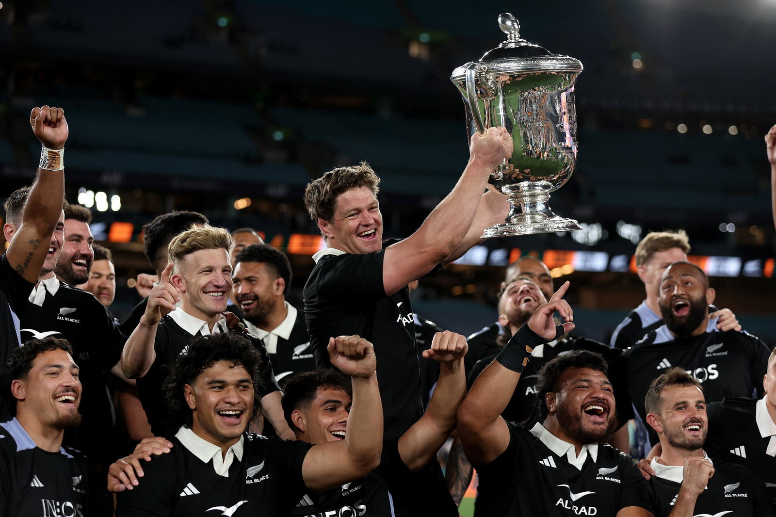 The All blacks hold up the Bledisloe Cup