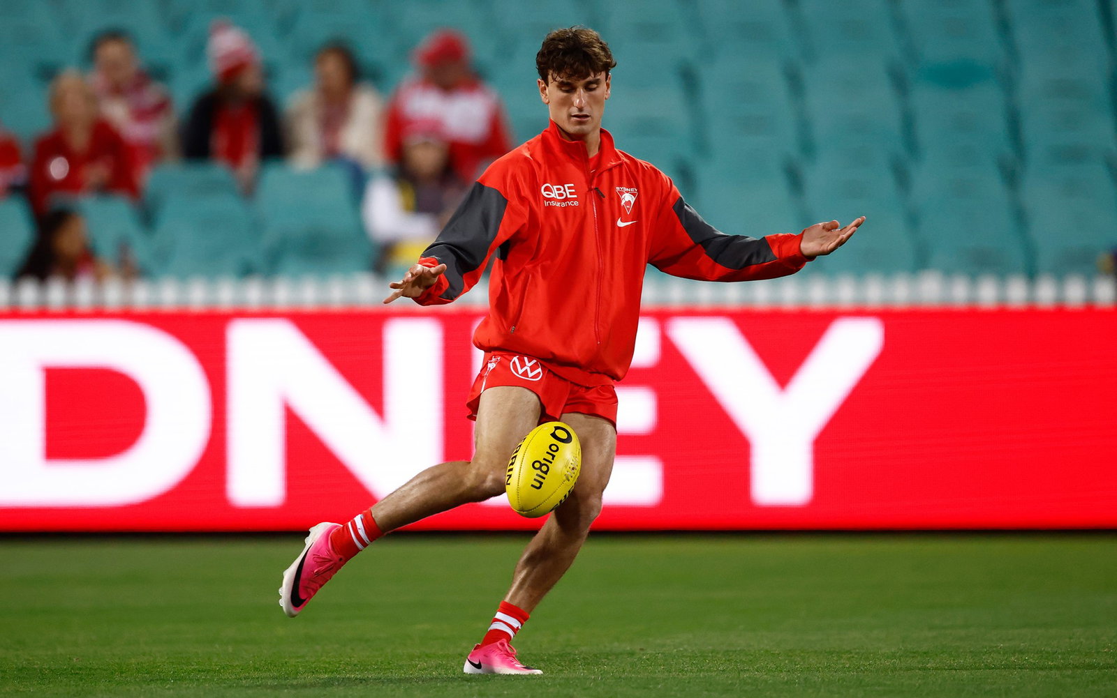 Sam Wicks kicks the football as a part of his pre-game warm-up.