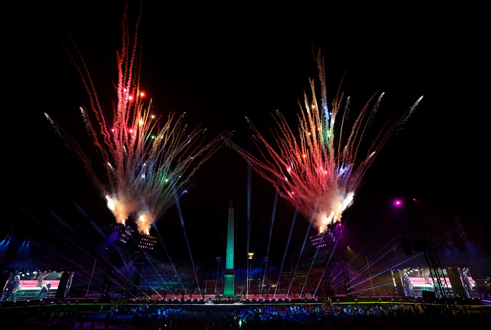 Fireworks go off as the Paralympic cauldron is lit in the background at the Paris Opening Ceremony.