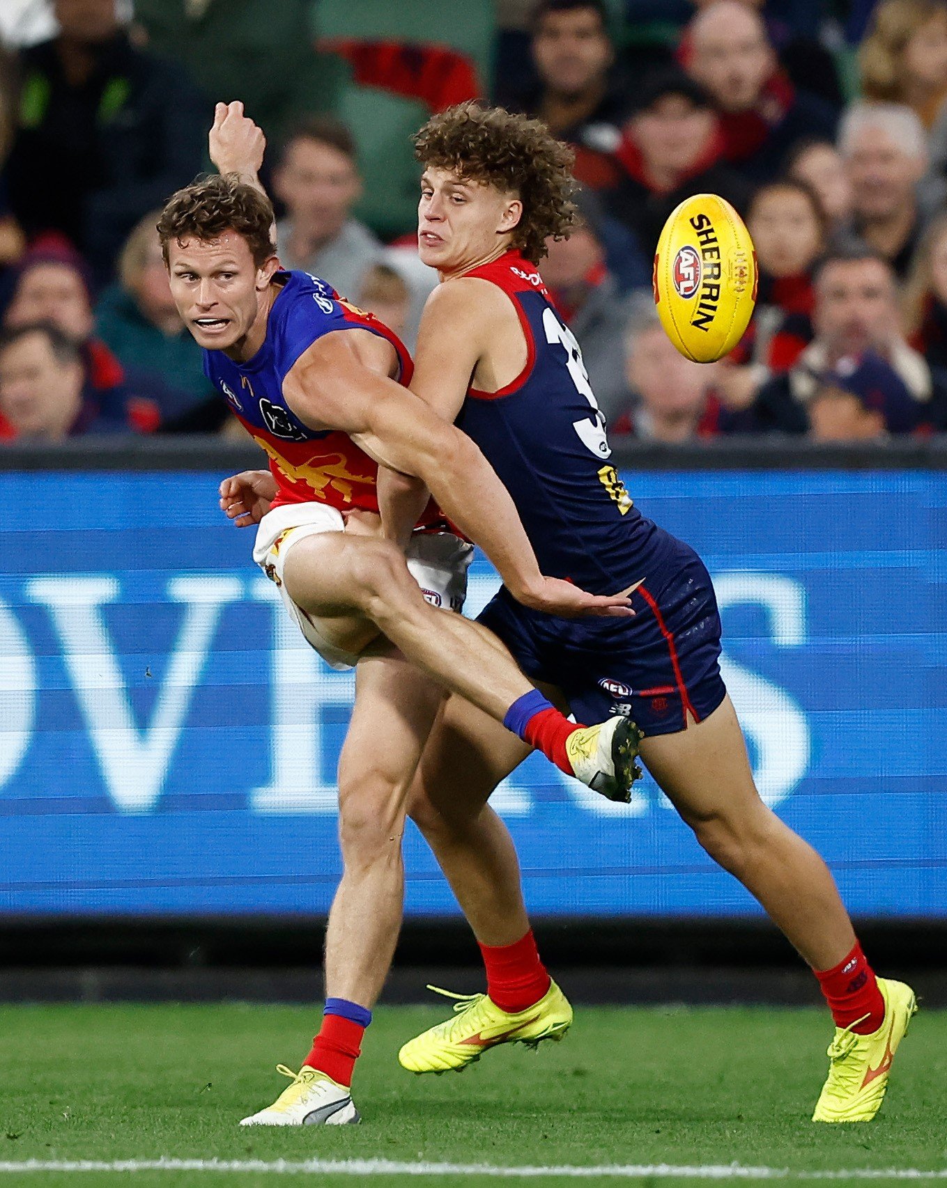 Ryan Lester of the Lions is tackled by Koltyn Tholstrup of the Demons during the 2024 AFL Round 05 match between the Melbourne Demons and the Brisbane Lions at the Melbourne Cricket Ground on April 11, 2024 in Melbourne, Australia.