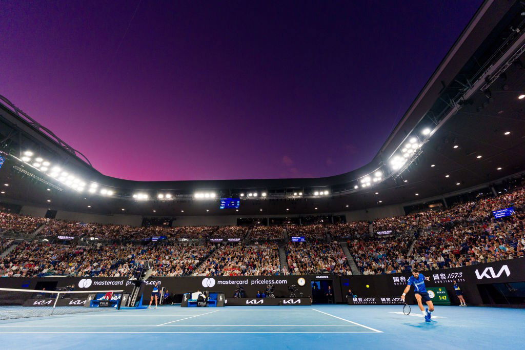 Rod Laver Arena at night watching Novak Djokovic.