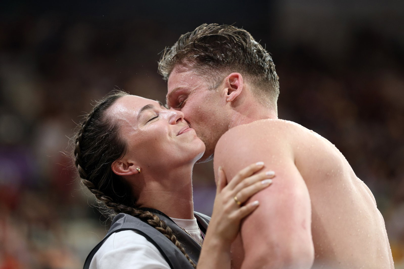 Sam Williamson kissing his partner on the cheek