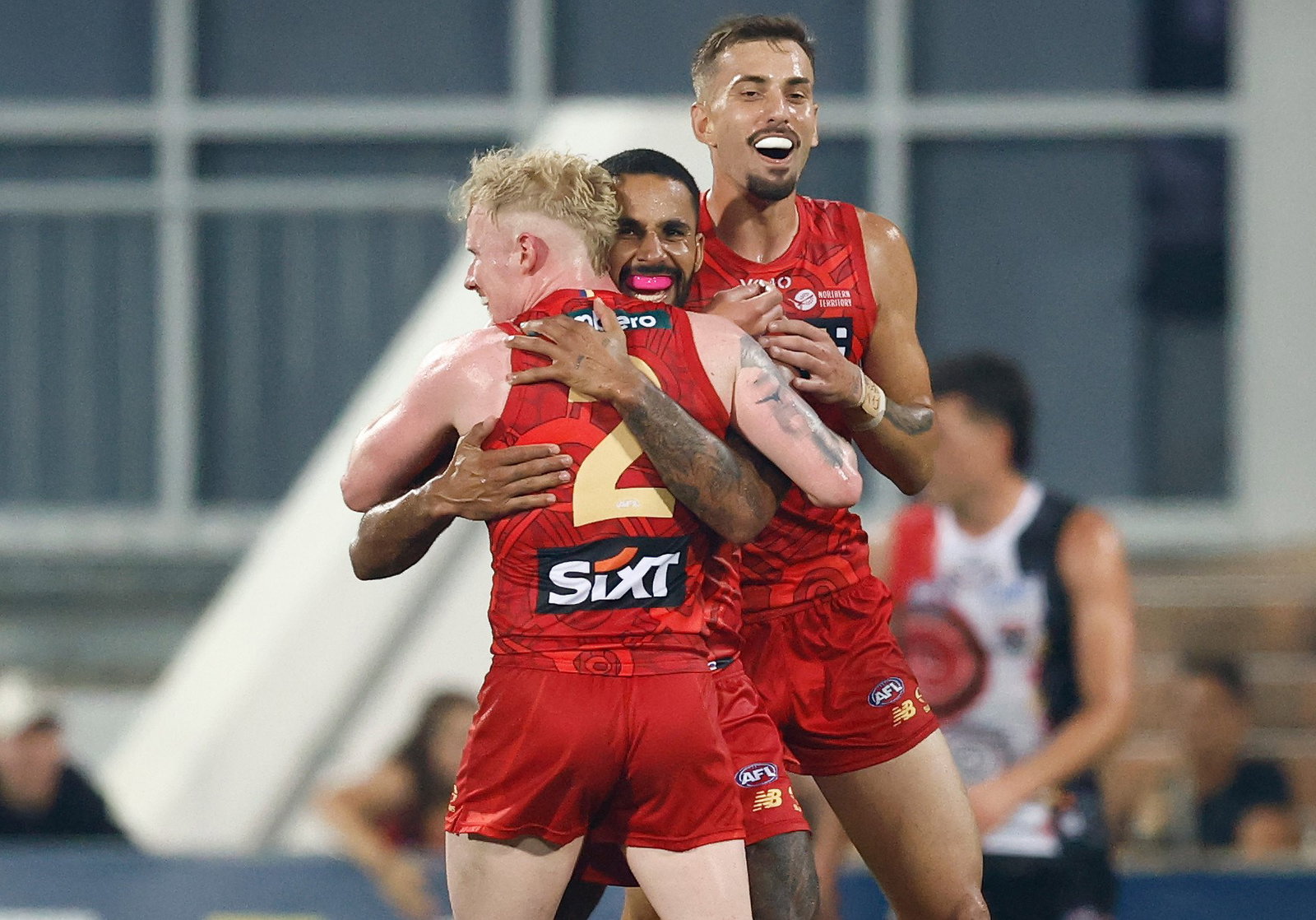 John Noble, Touk Miller and Joel Jeffrey of the Suns celebrate during the 2026 AFL Round 09 match between the Gold Coast Suns and the St Kilda Saints on May 9, 2026 in Darwin, Australia.