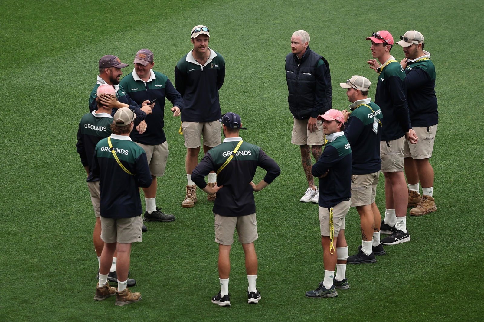 The SCG ground staff huddle before the match.