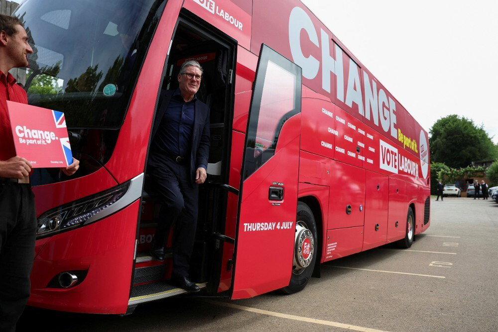 A man walking off a bus. The word 'change' can be seen on the side of the bus.