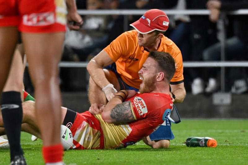 Euan Aitken of the Dolphins is treated for an injury during the NRL Round 19 match between the Redcliffe Dolphins and the South Sydney Rabbitohs at Kayo Stadium in Brisbane, Thursday, July 11, 2024. (