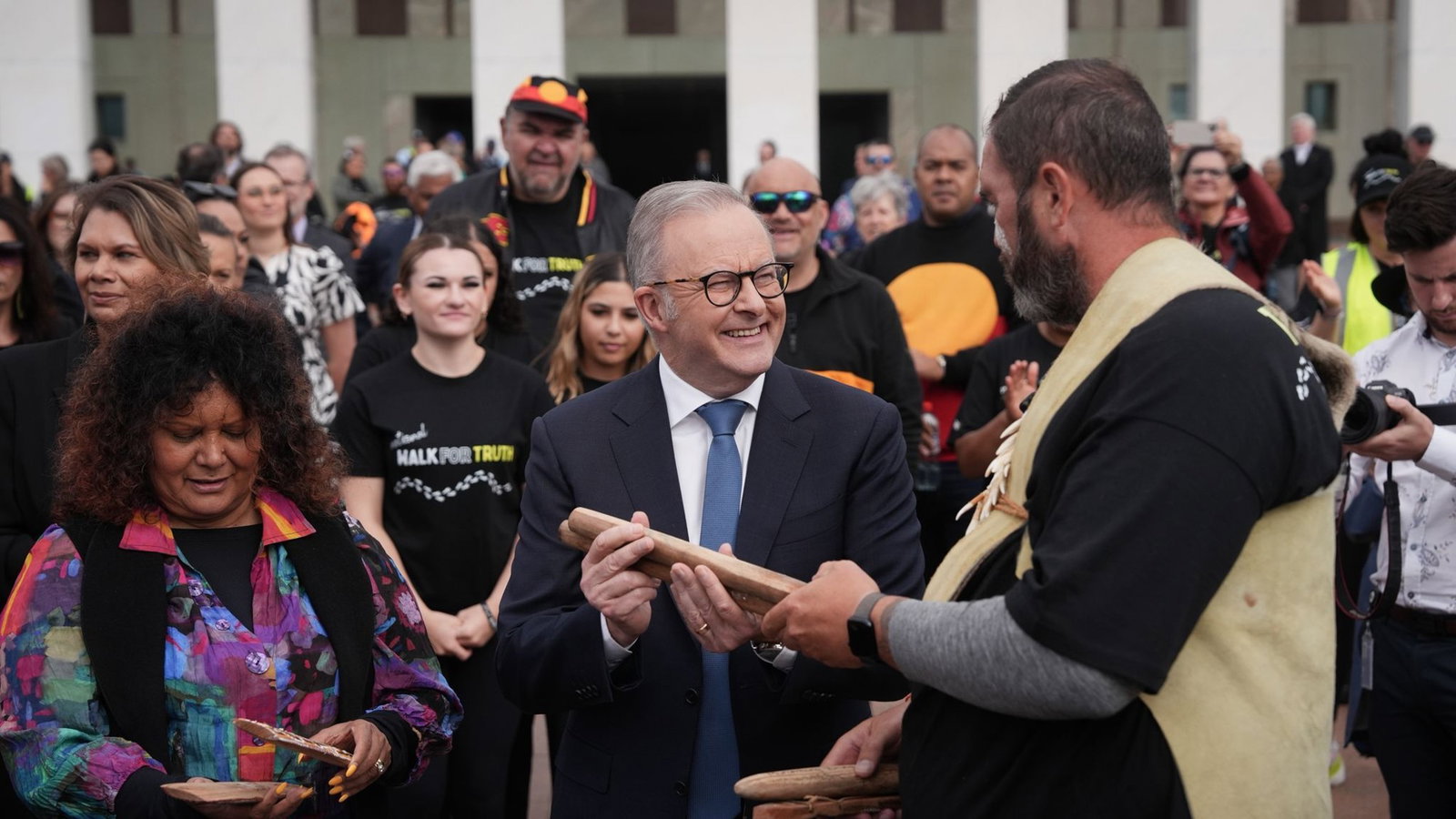 Lovett hands Albanese an item.