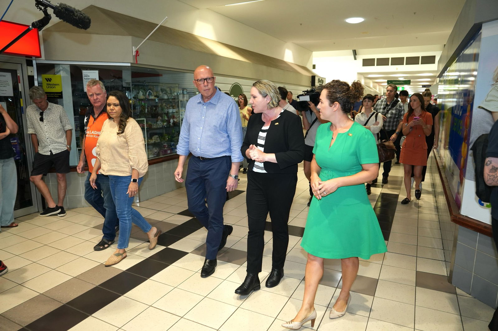 Jacinta Nampijinpa Price, Peter Dutton and Lia Finocchiaro walk through a shopping mall.