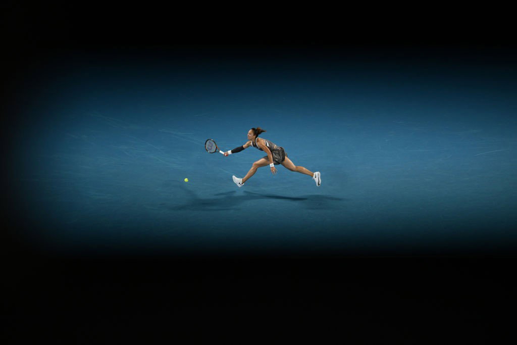 Qinwen Zheng runs for a forehand on Rod Laver Arena.