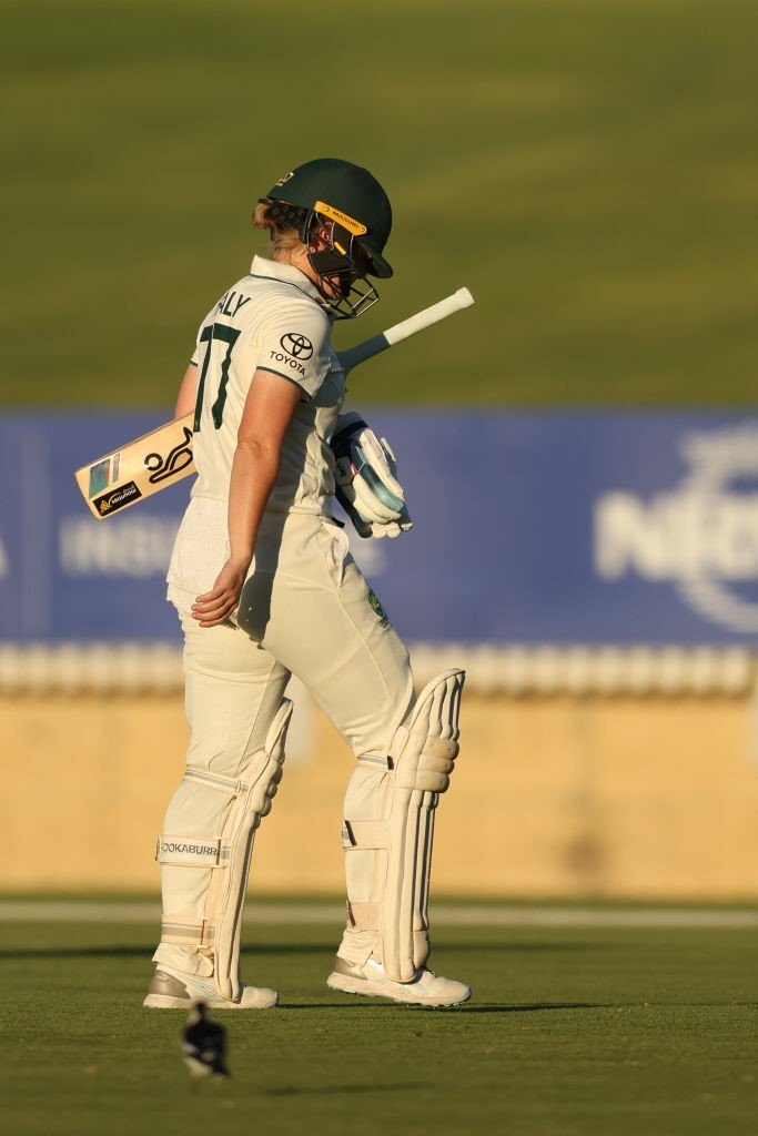 Australia batter Alyssa Healy walks off with her head down after getting out in a Test against South Africa.