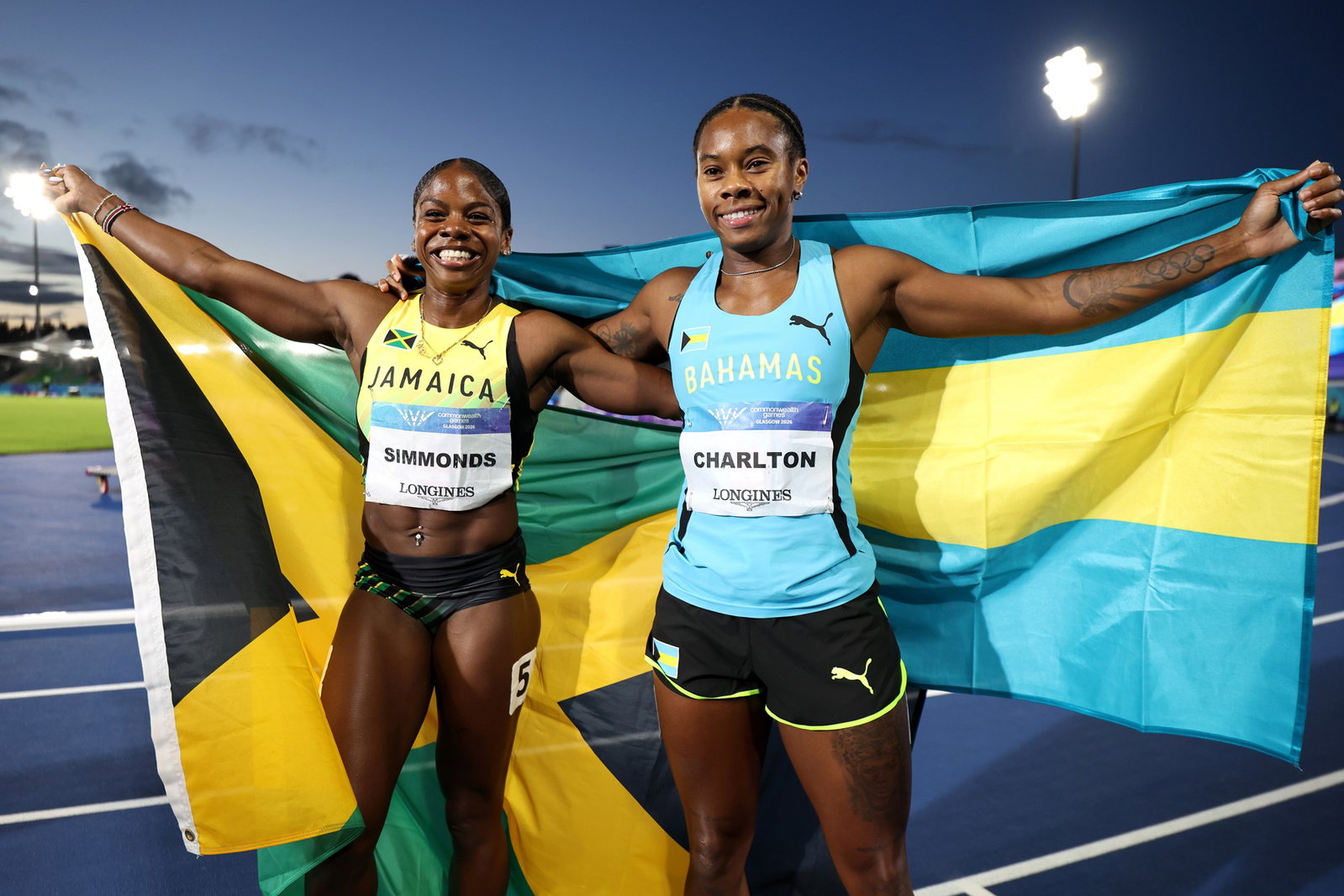 Megan Simmonds and Devynne Charlton with their national flags.