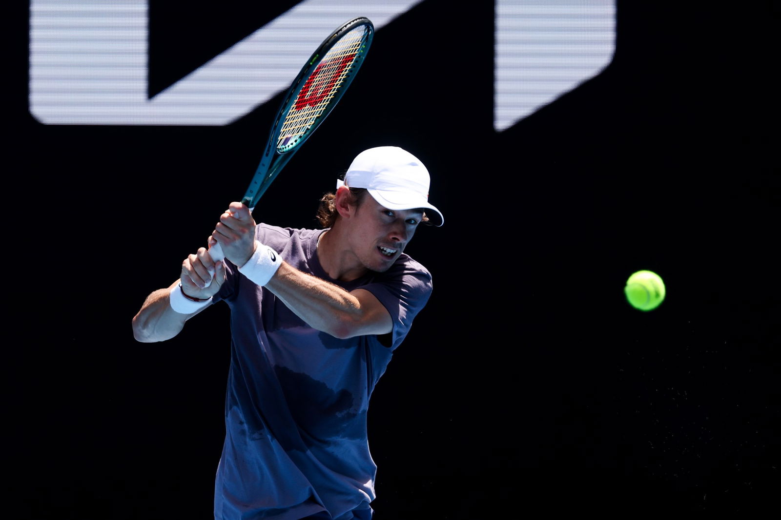 Alex De Minaur hits a backhand.