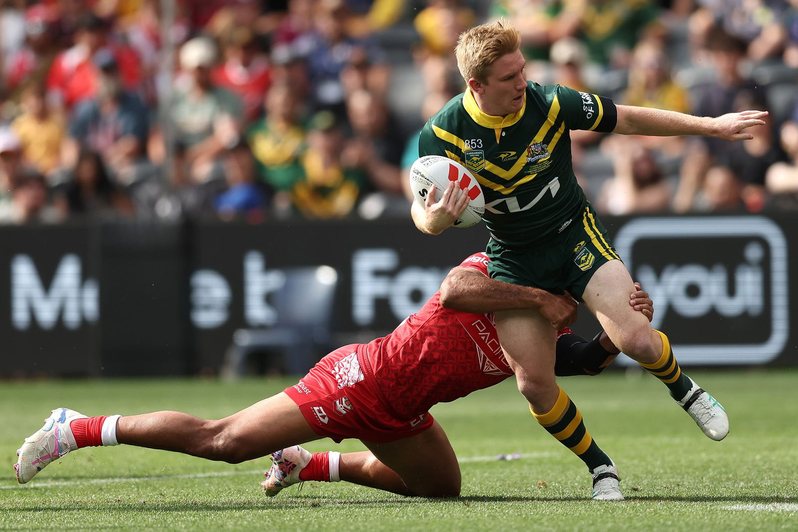 Tom Dearden is tackled while playing for Australia against Tonga.