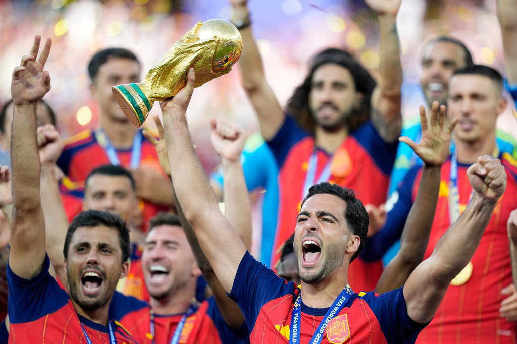 Mikel Merino celebrates with the trophy after winning the World Cup final.