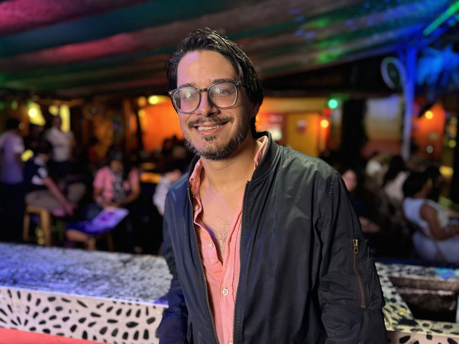 a smiling young man in an open-necked shirt