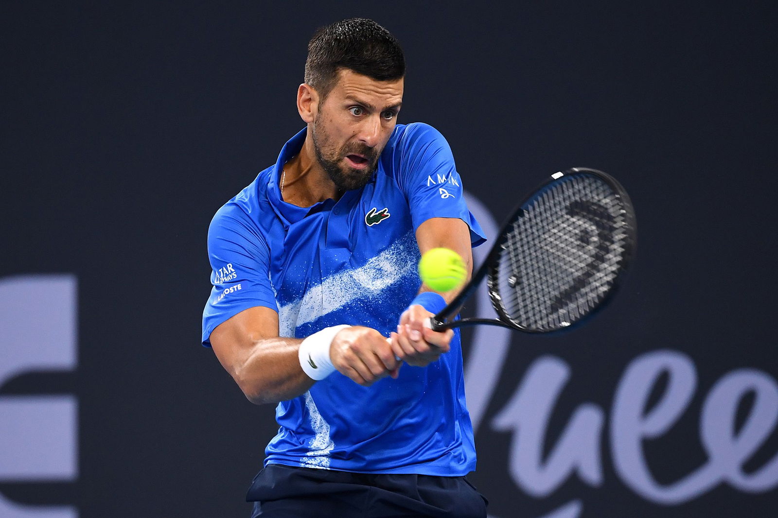 Novak Djokovic plays a double-fisted backhand.