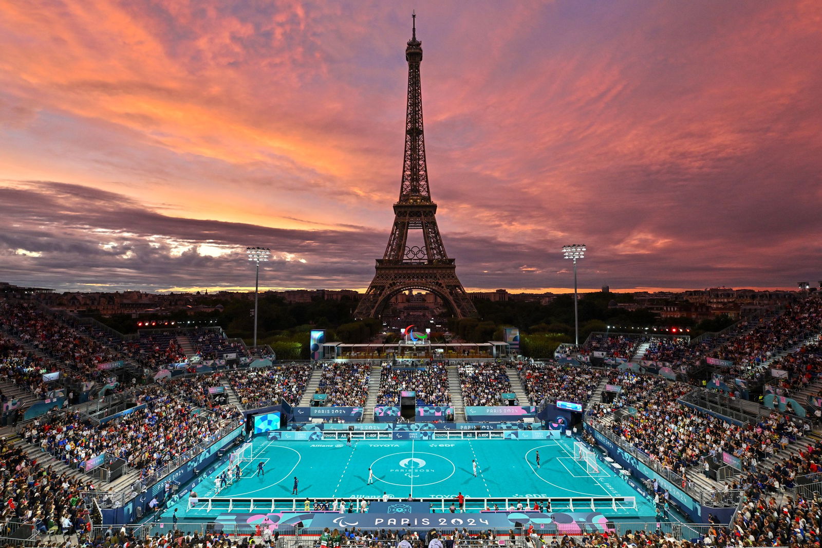 View of the action in men's blind football at sunset with the Eiffel Tower in the background.