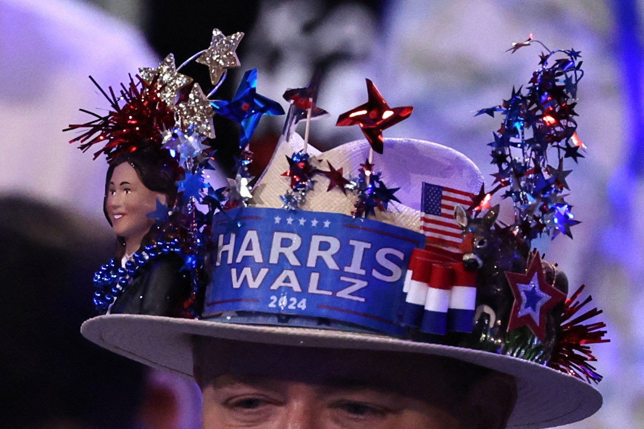 A close up of a patriotic hat that says Harris-Walz with a bust of Kamala Harris