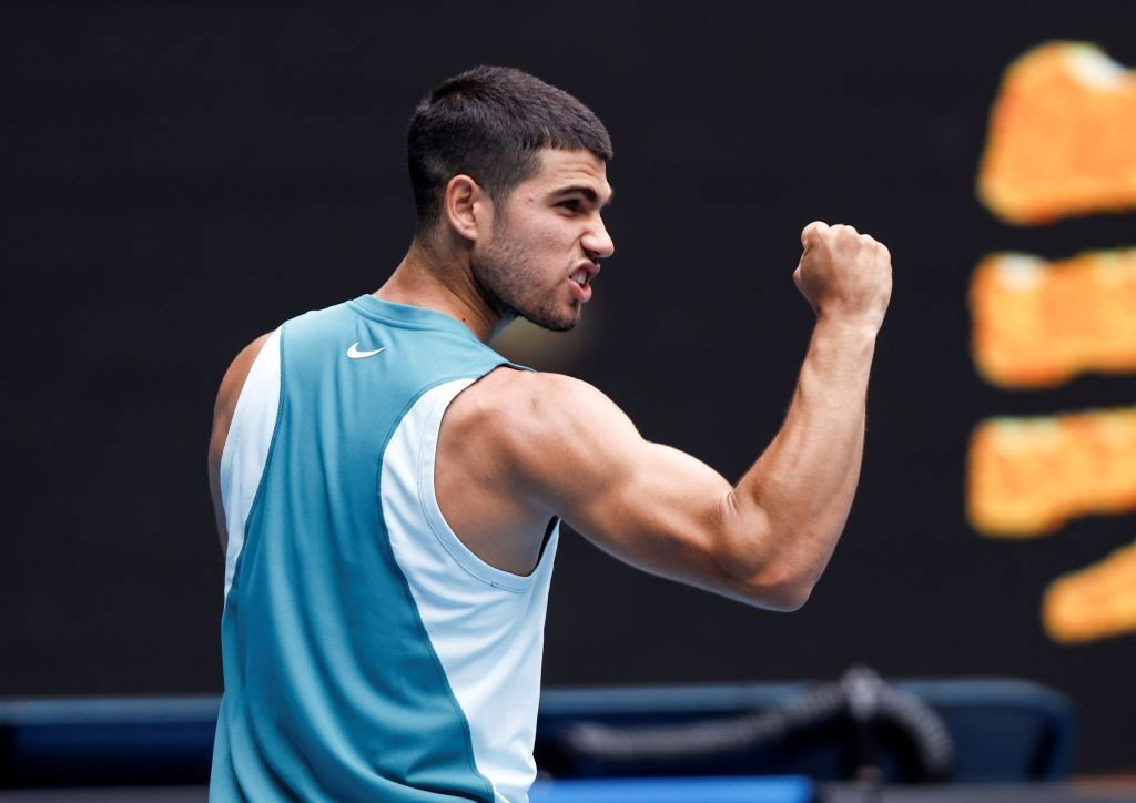 Carlos Alcaraz flexes his arm at the Australian Open.