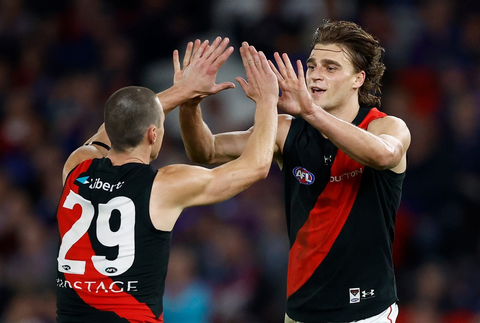 Jake Kelly (left) and Harrison Jones of the Bombers celebrate during the 2024 AFL Round 05 match between the Western Bulldogs and the Essendon Bombers at Marvel Stadium on April 12, 2024 in Melbourne, Australia
