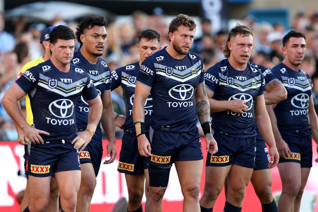 Cowboys players look sad after conceding a try by the Sharks.