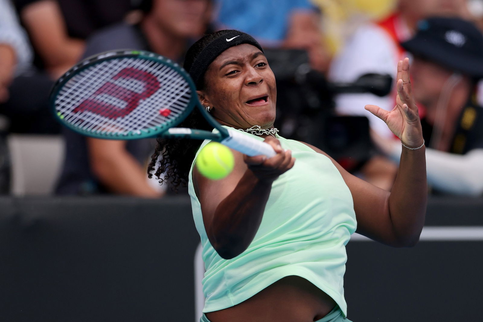 Hailey Baptiste plays a forehand return