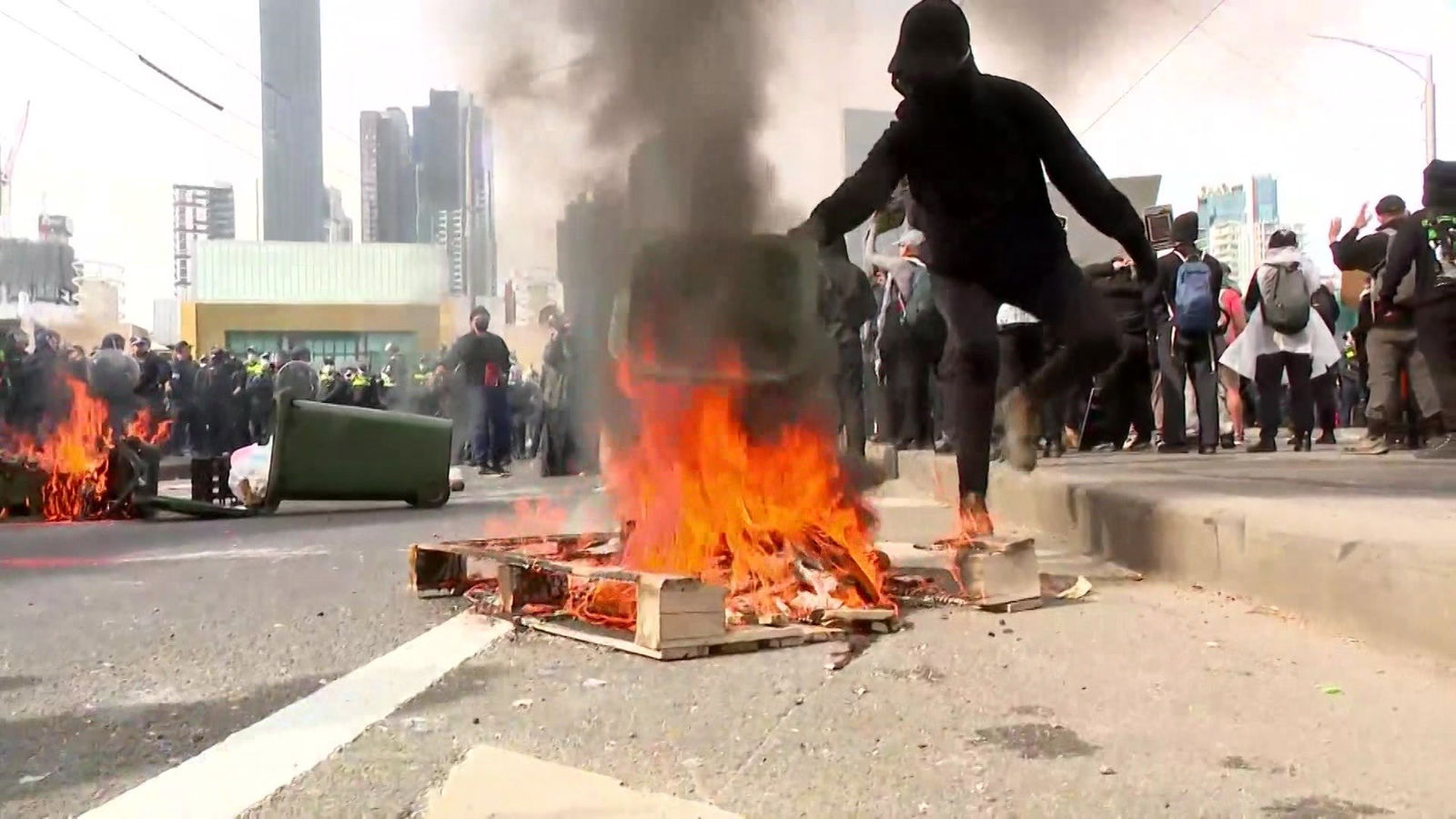 a fire on a bridge at a protest