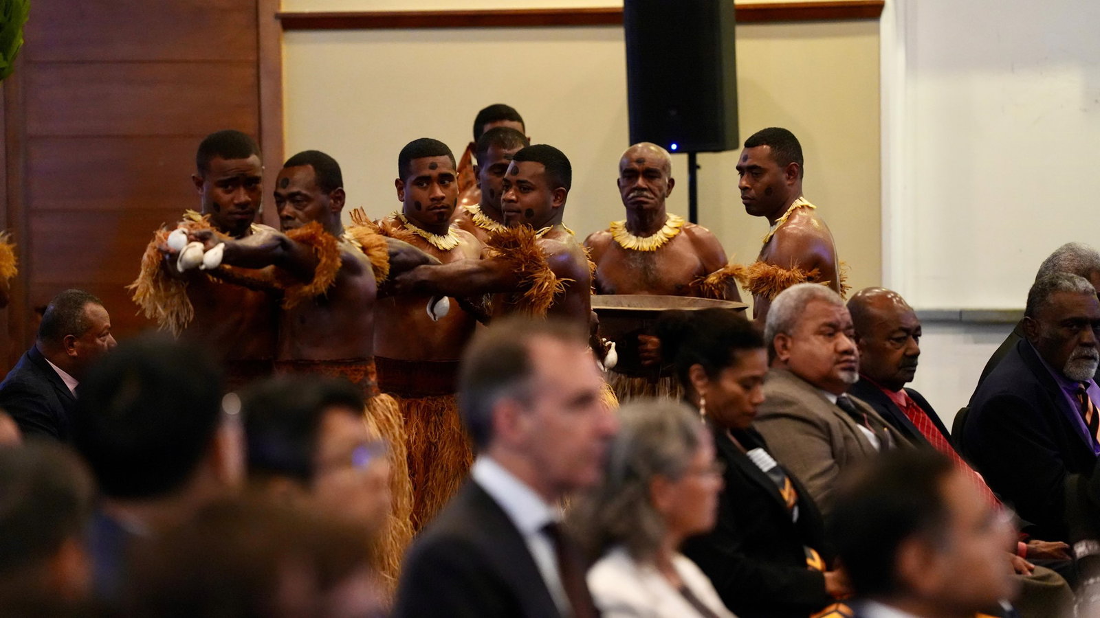 Men particpate in official welcoming ceremony.