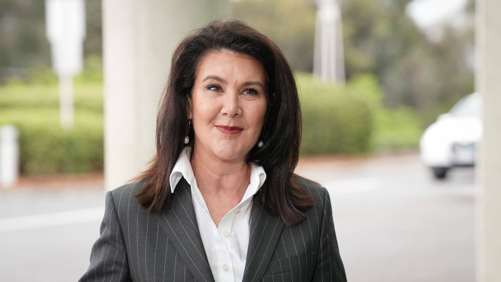 A woman in a suit outside