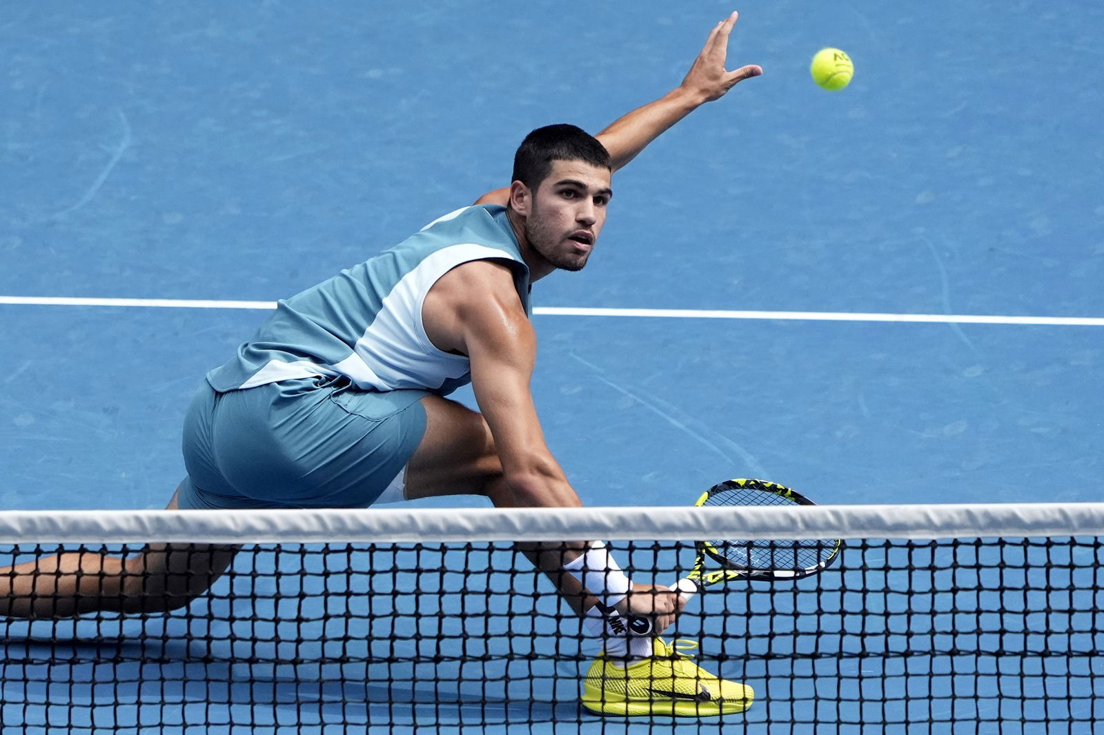 Carlos Alcaraz plays a backhand volley at the Australian open.