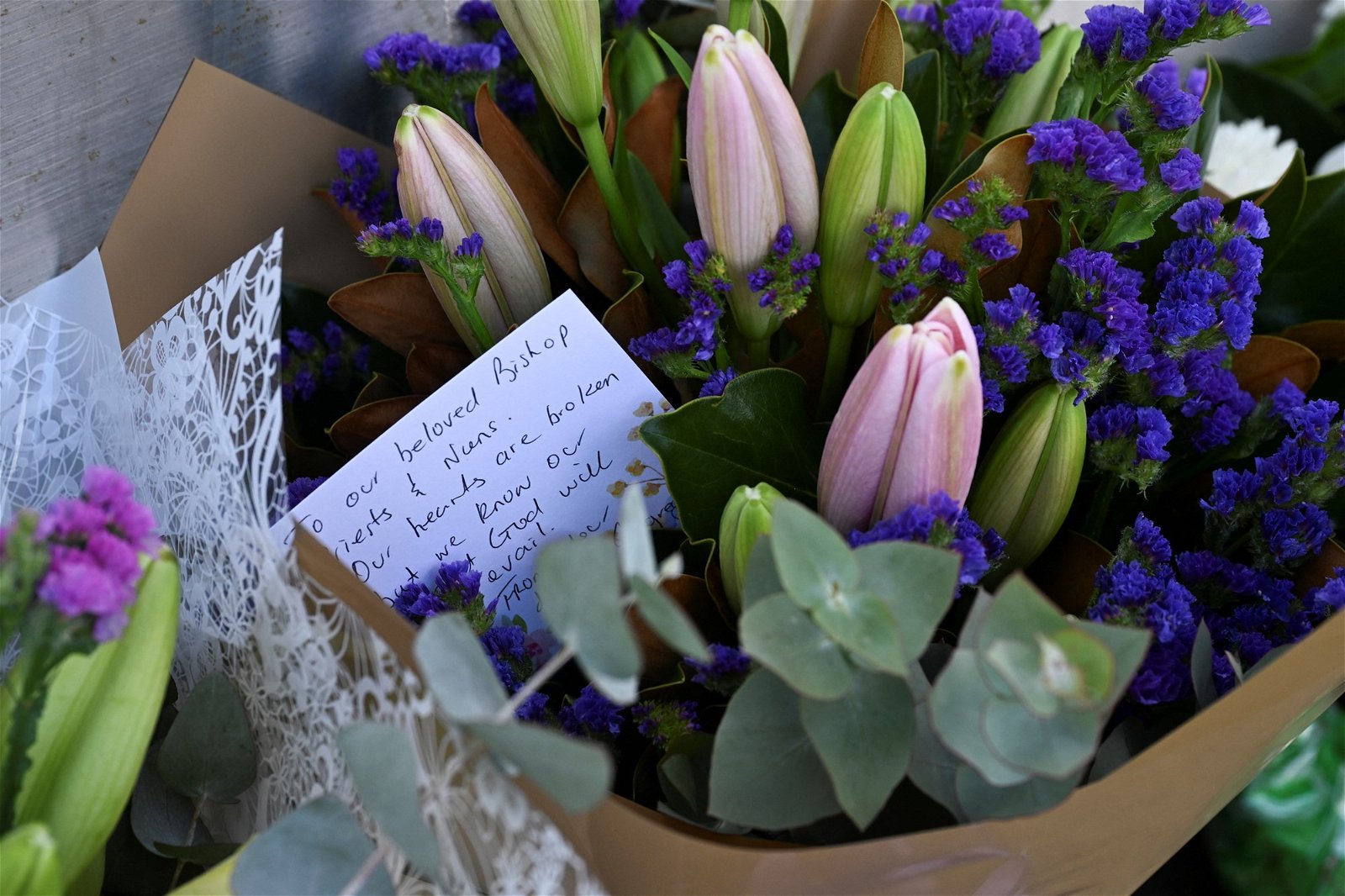 Closeup of flowers and a note.