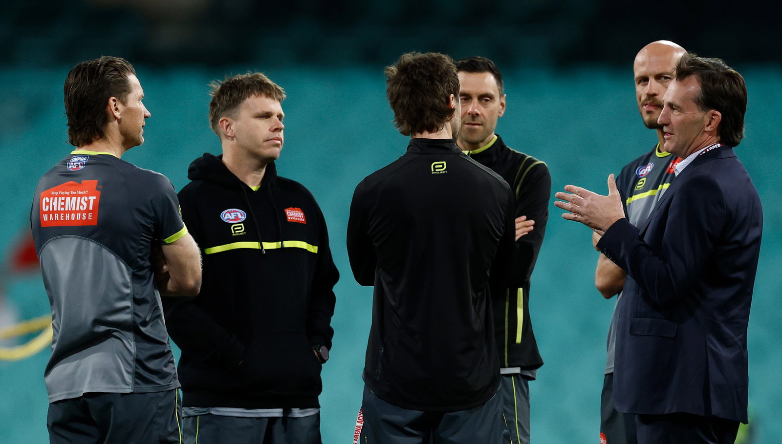 AFL boss Andrew Dillon chats to umpires ahead of the preliminary final