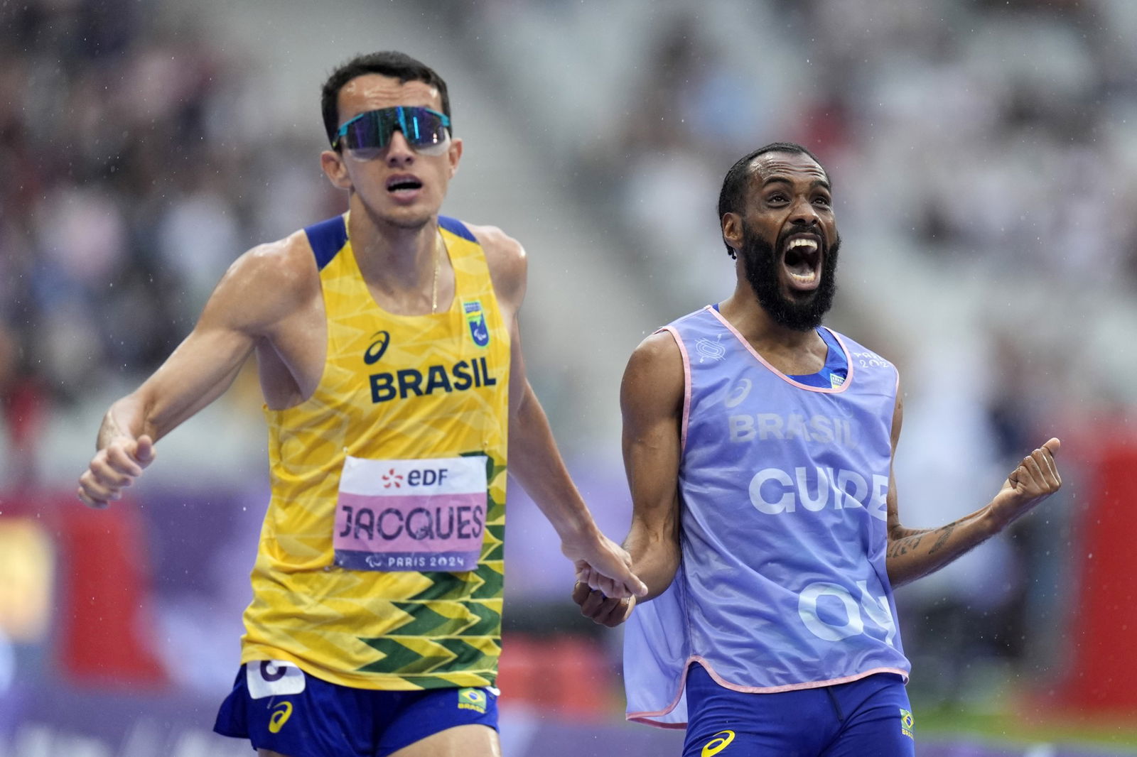 Brazil's Yeltsin Jacques and guide Guilherme dos Anjos Santos celebrate after the men's 1500m T11 final in Paris.