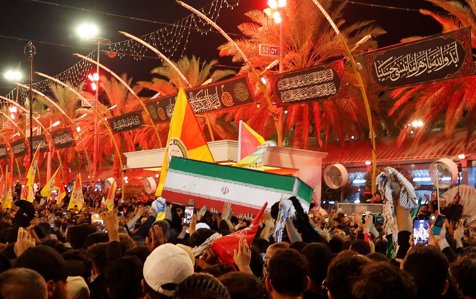 Ali Khamenei's coffin being carried by a large crowd