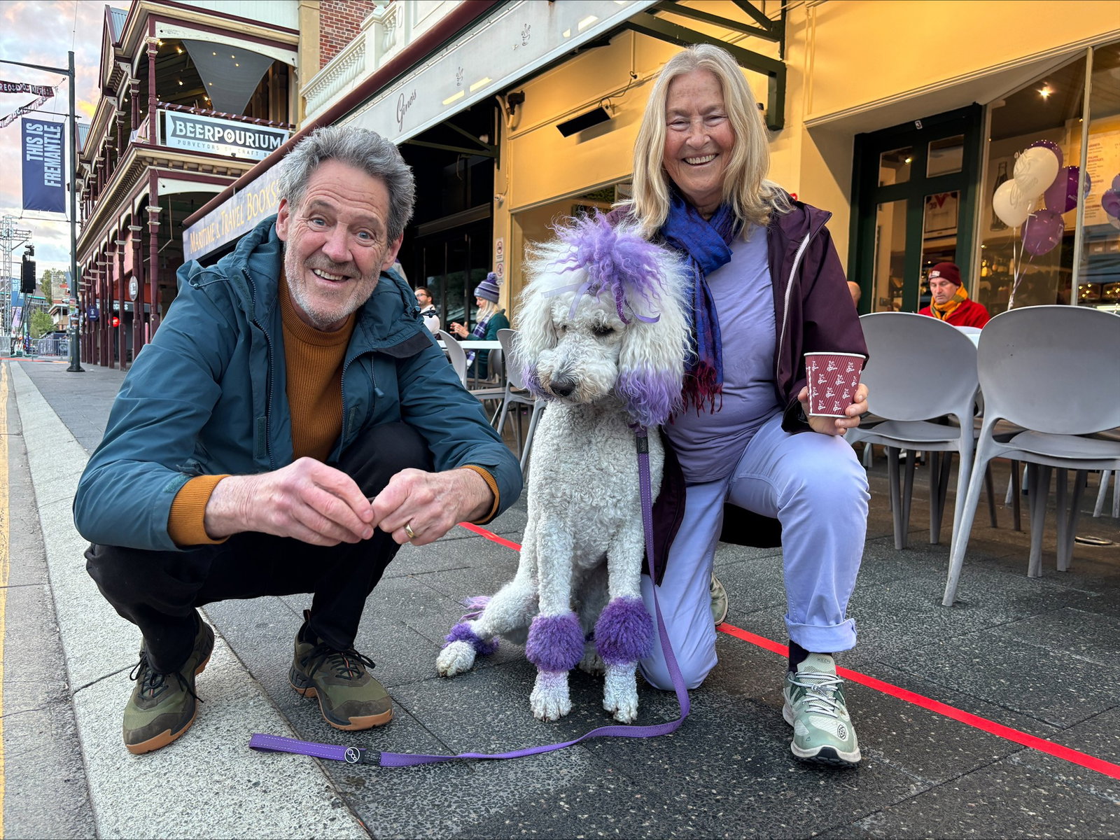 Mark Cairn, Sue Thorman amd Chester the poodle in Perth on grand final day.