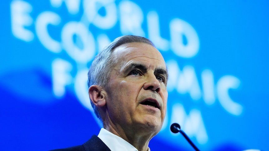 Mark Carney speaks in front of a 'World Economic Forum' screen.
