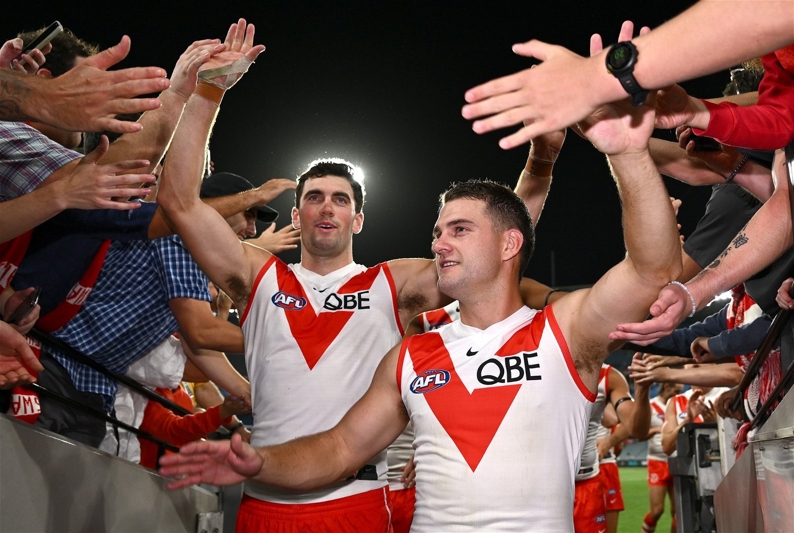 Tom McCartin and Tom Papley celebrate with Sydney fans at the MCG.