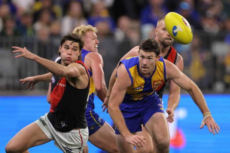 Essendon's Sam Durham and West Coast's Jeremy McGovern compete for the ball.