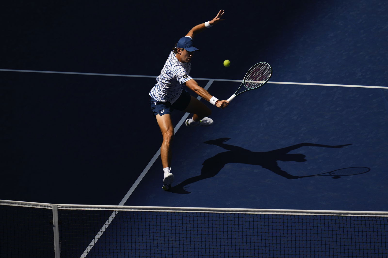 Alex De Minaur on the court playing a tennis shot