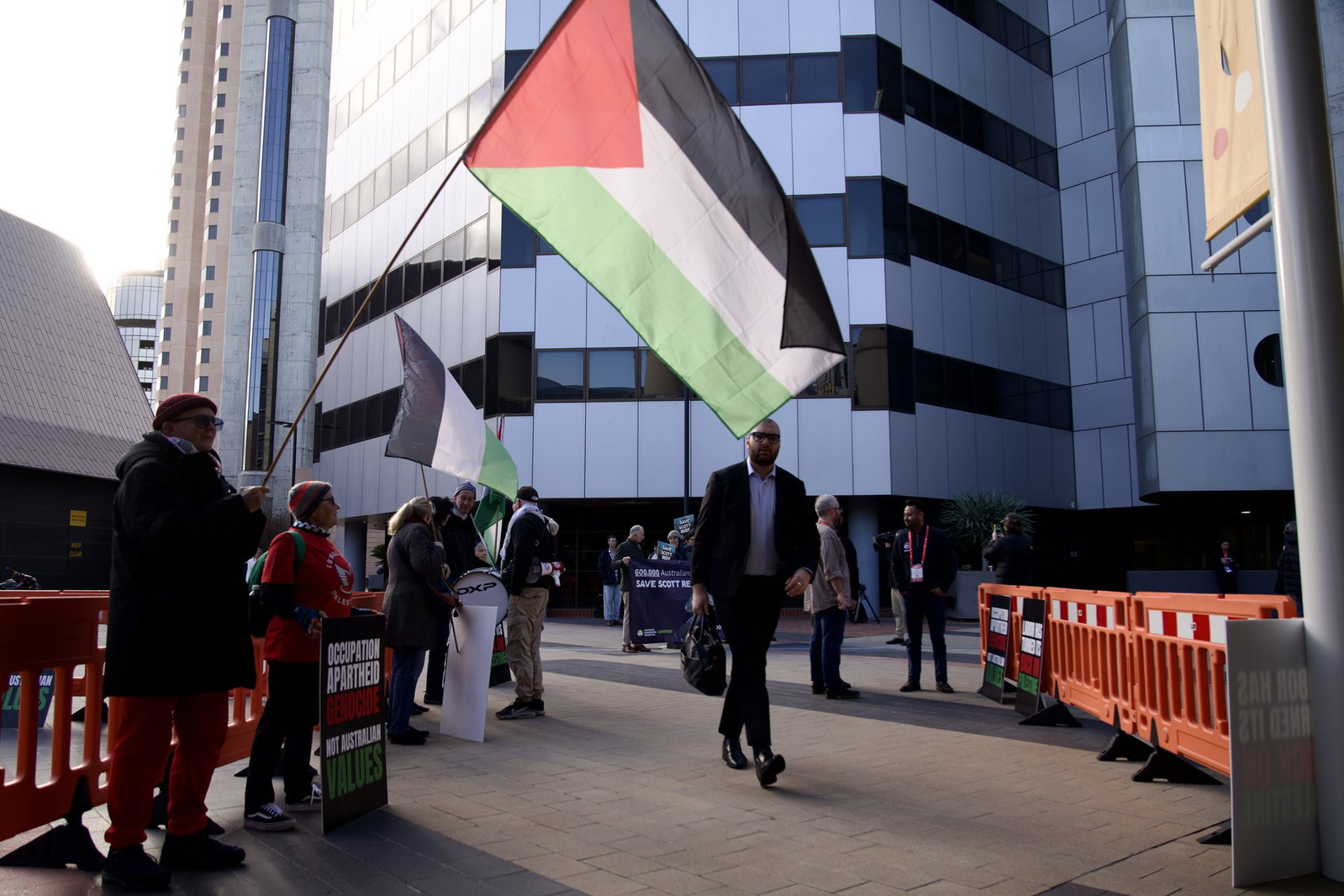 Protesters hold a Palestinian flag outside the Labor conference.