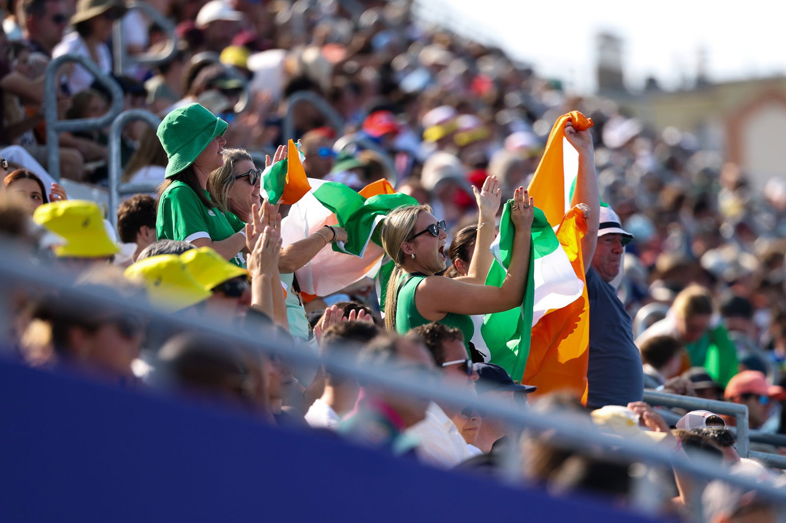 Irish sporting fans cheer at a hockey stadium.