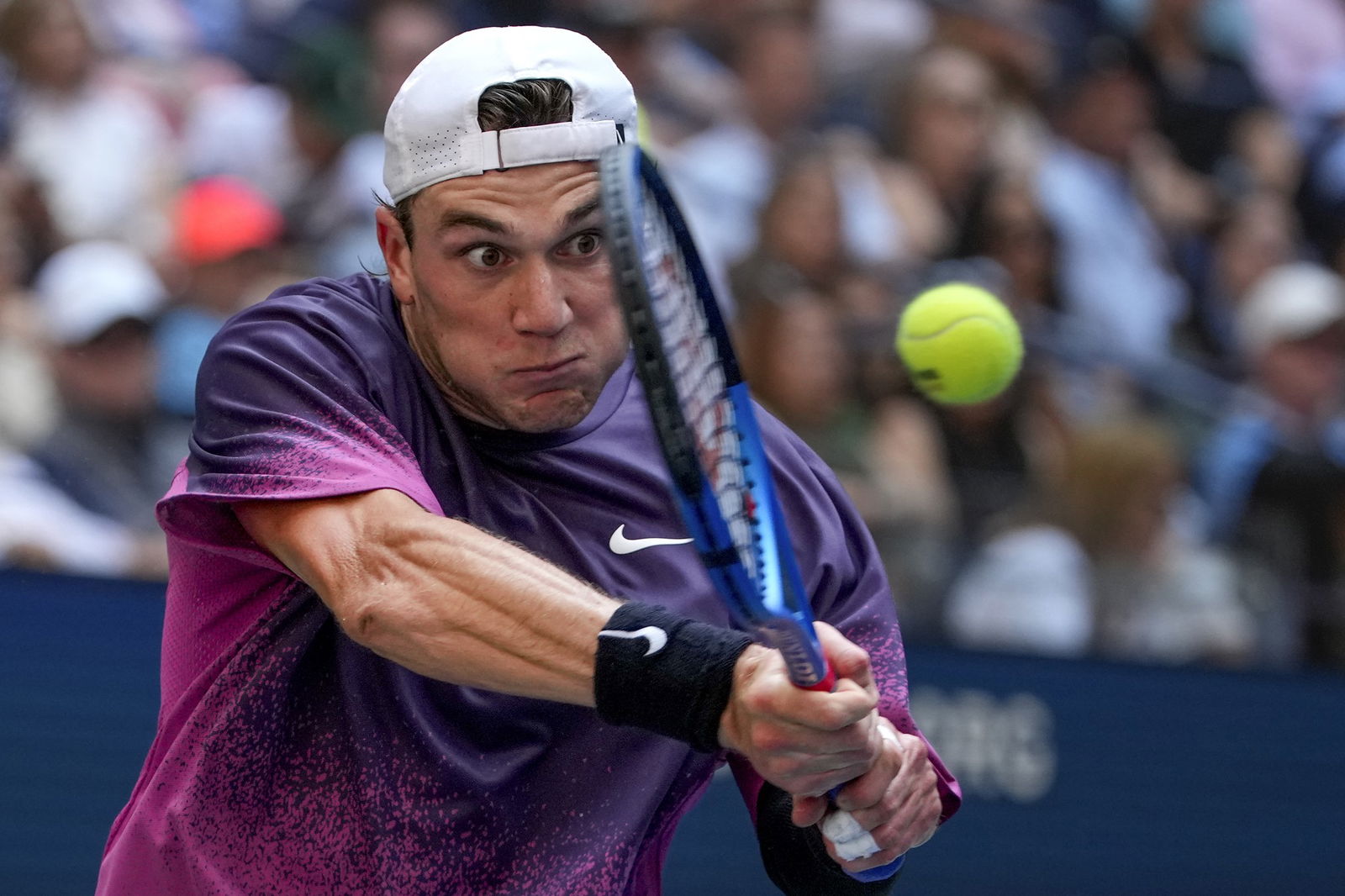 Jack Draper hitting a tennis ball with his racquet